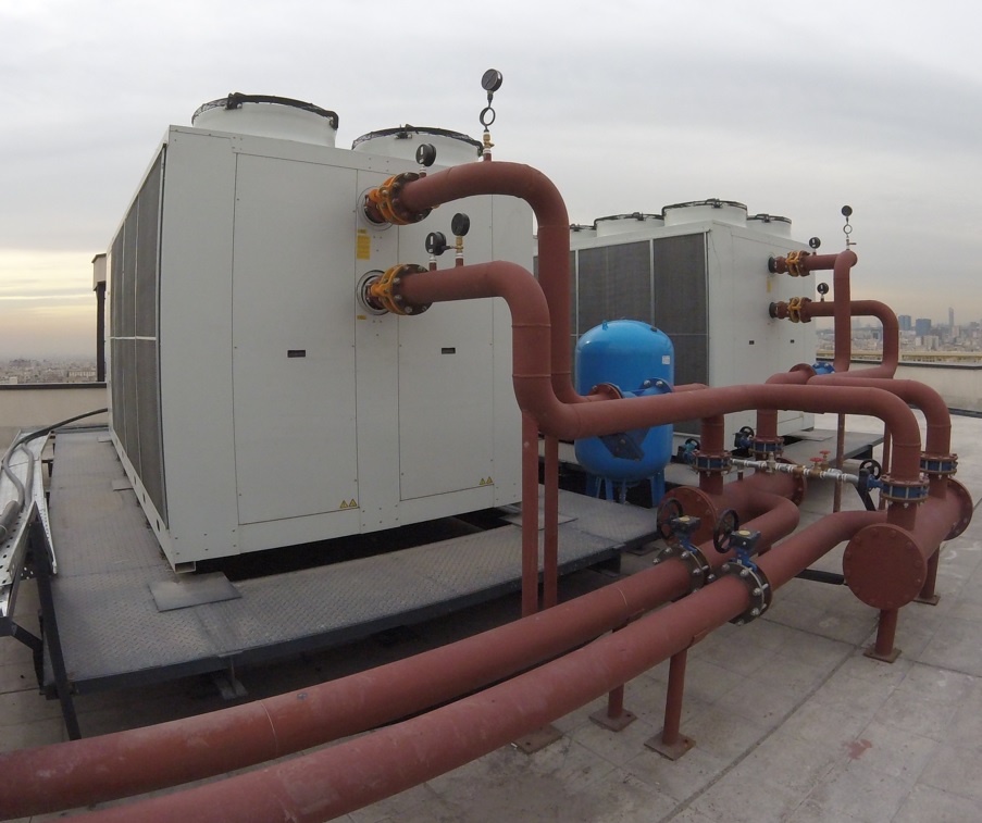 Industrial HVAC and energy system installation with piping and cooling units, part of Green Tech renewable energy and climate-control solutions